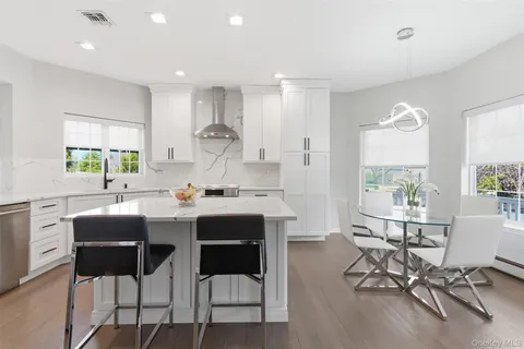 a kitchen with a sink a stove and cabinets