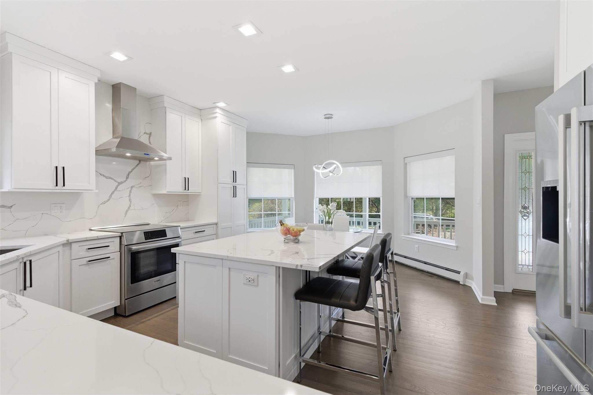 159 Rivendell Court Melville, NY 11747 - Photo 10 of 38 a kitchen with a sink a stove a refrigerator and white cabinets with wooden floor
