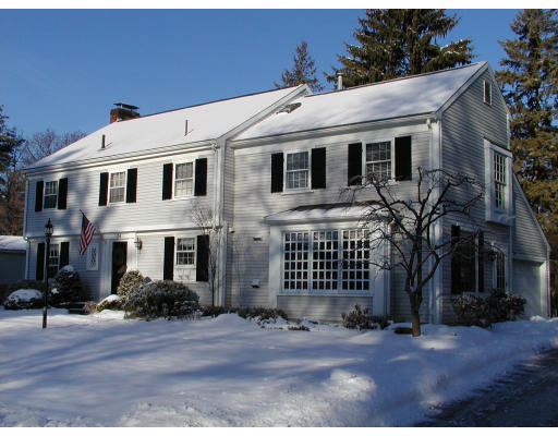 24 Oxford Road Wellesley, MA 02481 - Photo 1 of 9 a view of a white house with many windows next to a road