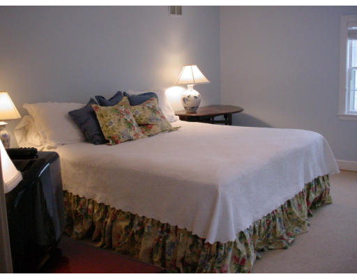 24 Oxford Road Wellesley, MA 02481 - Photo 8 of 9 a bedroom with a bed and lamp