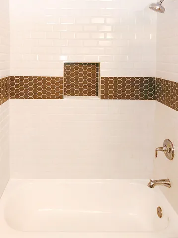 a bathroom with a bathtub and a shower