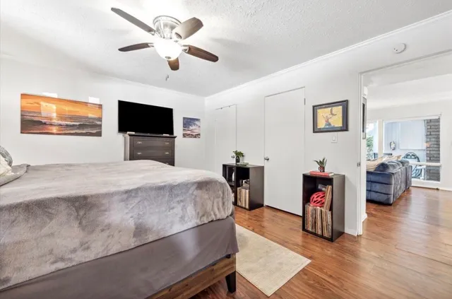 a bedroom with a bed and a chandelier