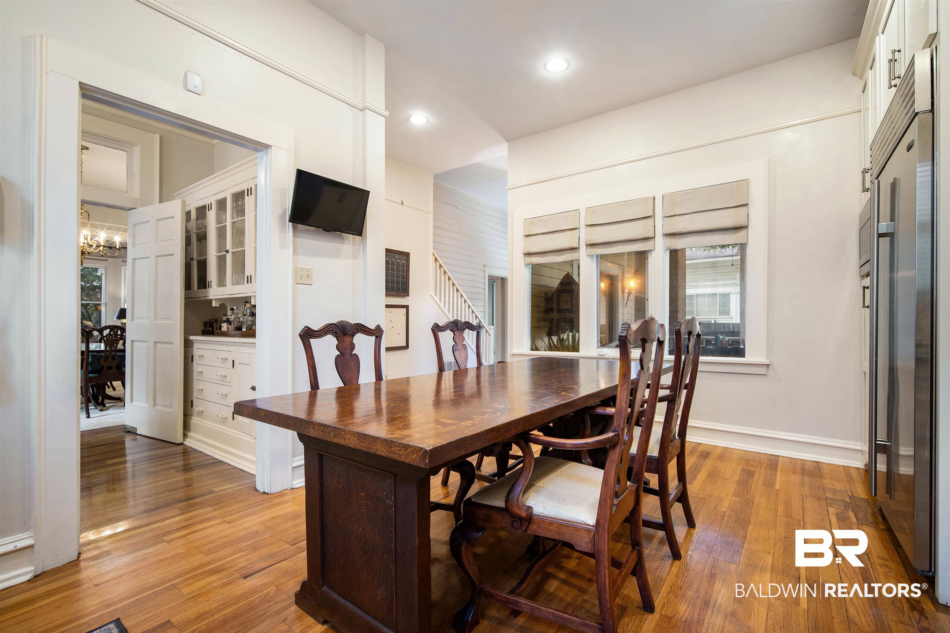 1314 Dauphin Street Mobile, AL 36604 - Photo 23 of 61 Dining space in kitchen with hardwood flooring and an inviting chandelier