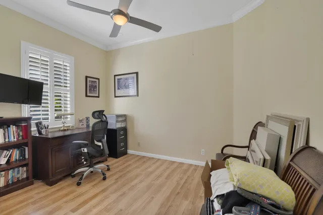 a living room filled with furniture and a large window