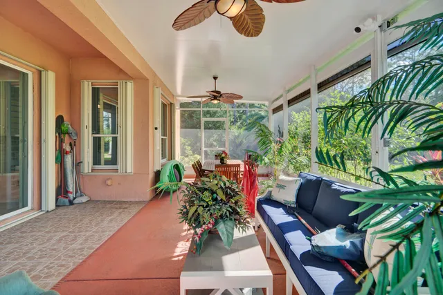 a view of a patio with table and chairs with potted plants