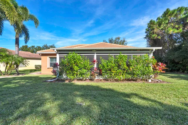 a view of a brick house with plants