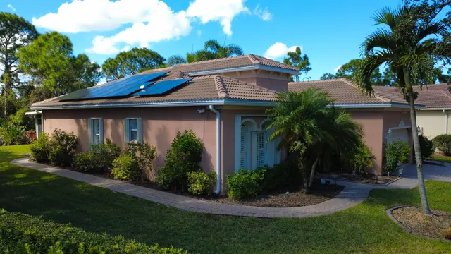 a view of a house with a swimming pool and a yard