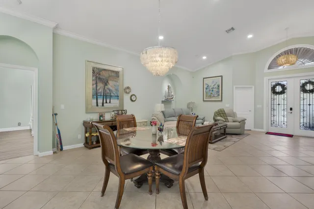 a view of a dining room with furniture and chandelier