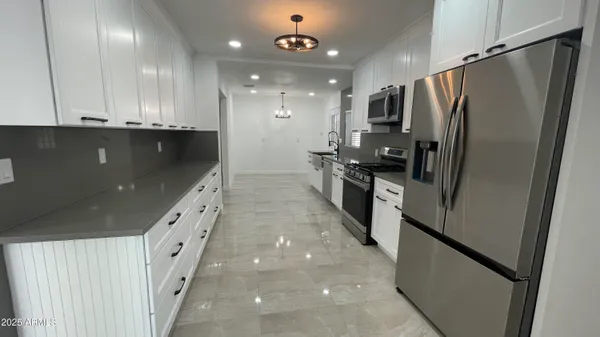a bathroom with a granite countertop toilet sink and mirror