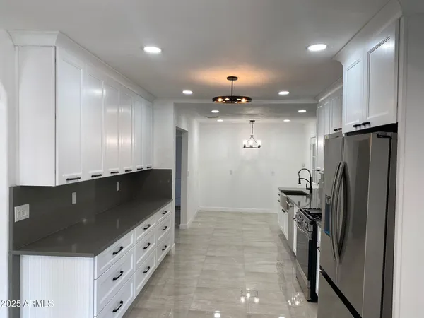 a white house that has a tree in front of it