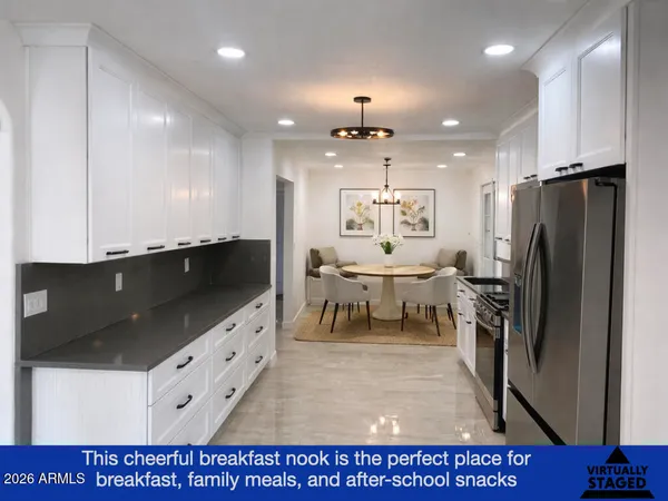 a kitchen with stainless steel appliances kitchen island granite countertop a refrigerator and a sink