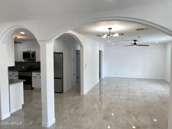 a kitchen with stainless steel appliances a refrigerator stove microwave and sink