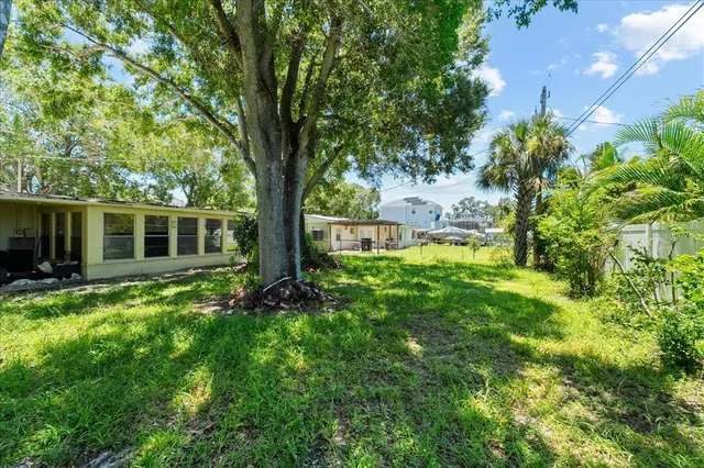 a view of backyard of house with green space