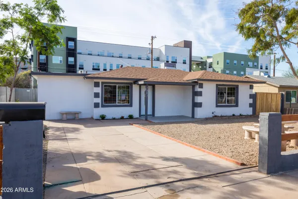 a front view of a house with a garden
