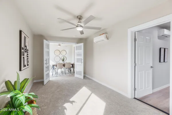 a view of a livingroom with workspace and a window