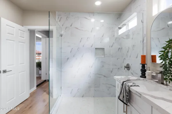 a bathroom with a tub sink and shower