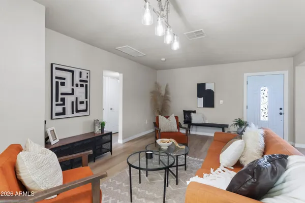 a living room with furniture and wooden floor