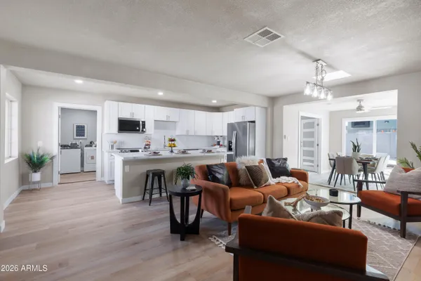 a living room with furniture and kitchen view