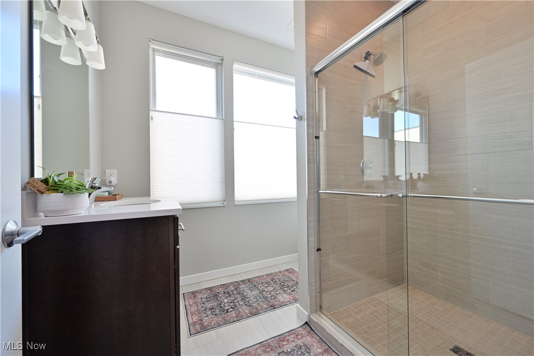 18875 Riversouth Fairview Park, Unit 30 Cleveland, OH 44126 - Photo 24 of 39 Full bathroom featuring vanity, a shower stall, and tile patterned floors