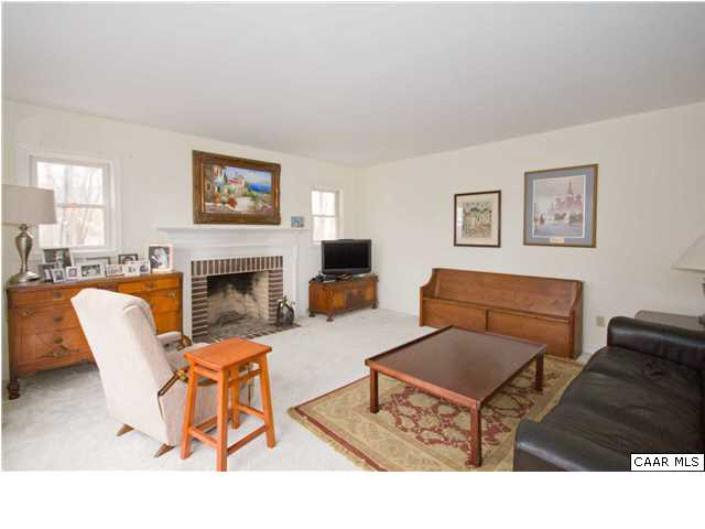 60 Laguna Road Palmyra, VA 22963 - Photo 7 of 25 a living room with furniture a flat screen tv and a fireplace