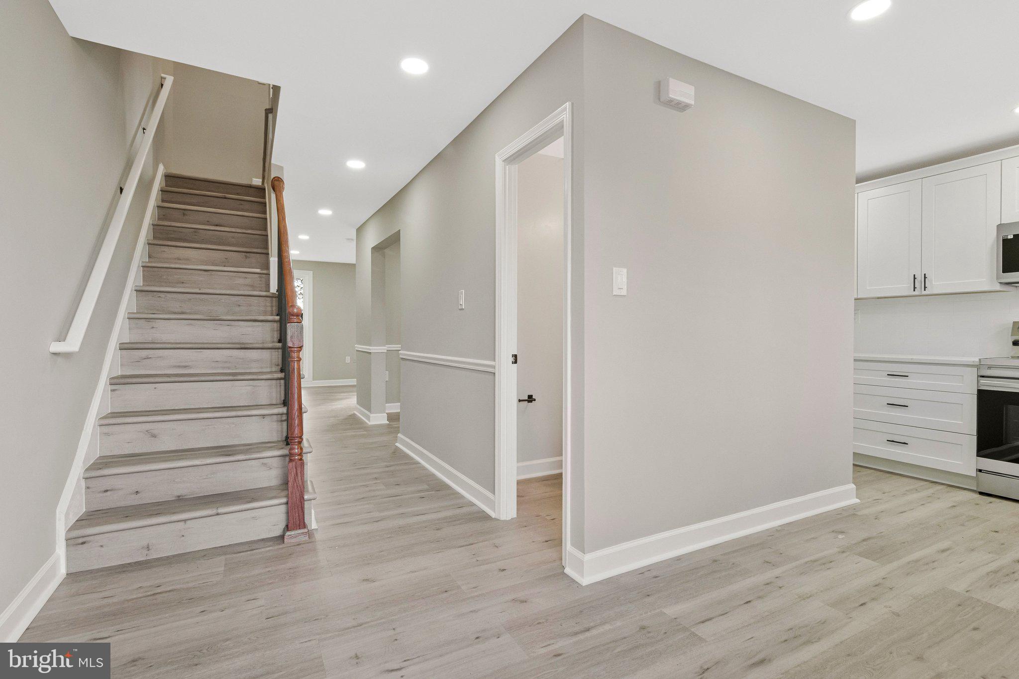 7269 Evanston Road Springfield, VA 22150 - Photo 11 of 41 a view of a hallway with wooden floors and staircase