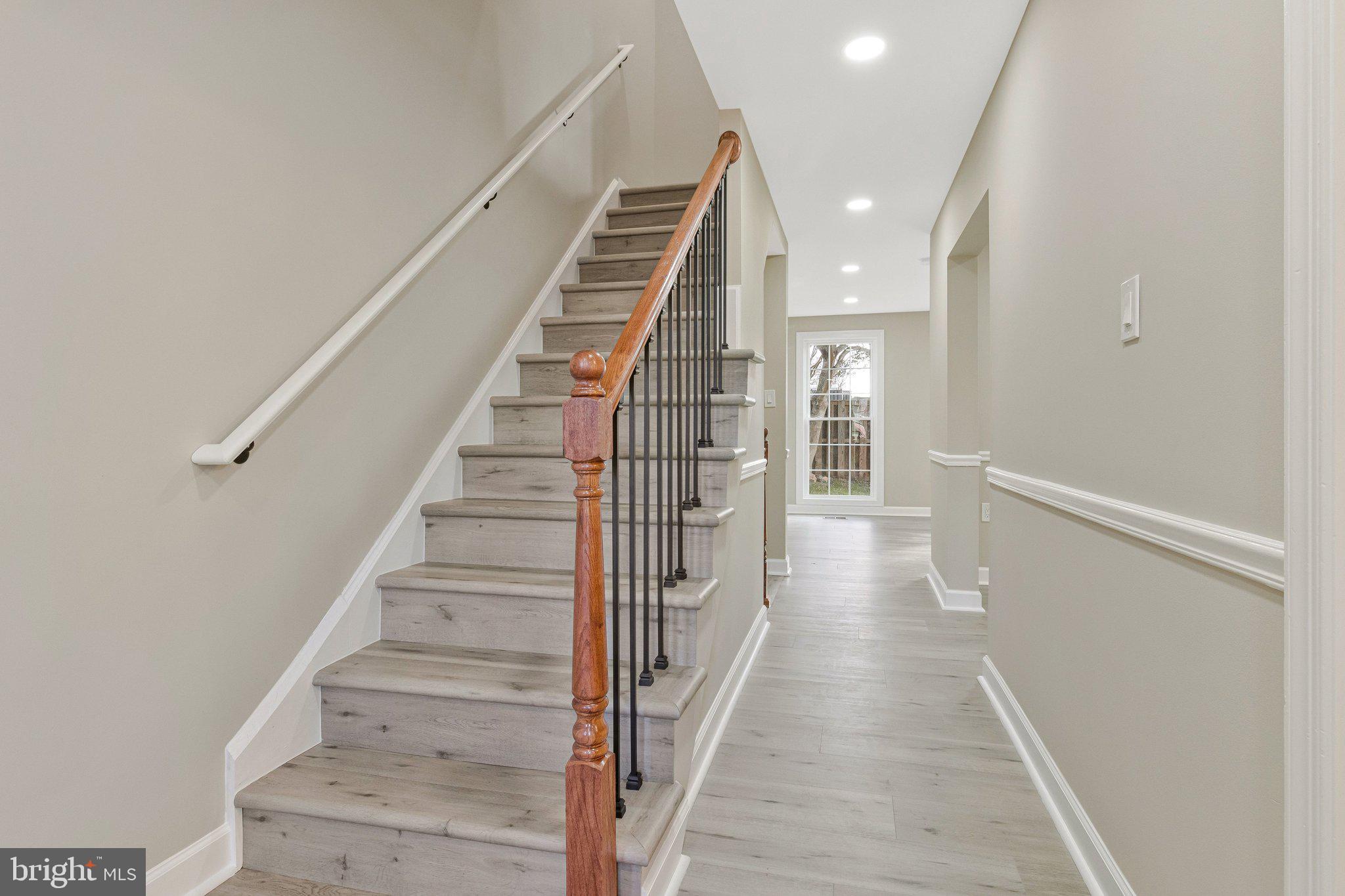 7269 Evanston Road Springfield, VA 22150 - Photo 12 of 41 a view of staircase with wooden floor and white walls