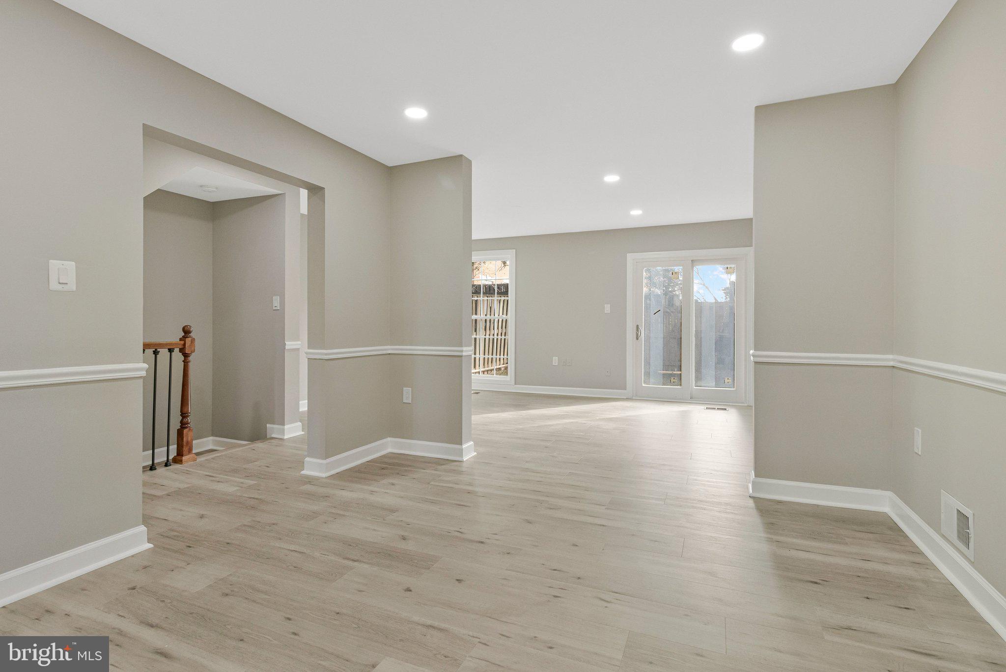 7269 Evanston Road Springfield, VA 22150 - Photo 13 of 41 a view of an empty room with wooden floor and kitchen