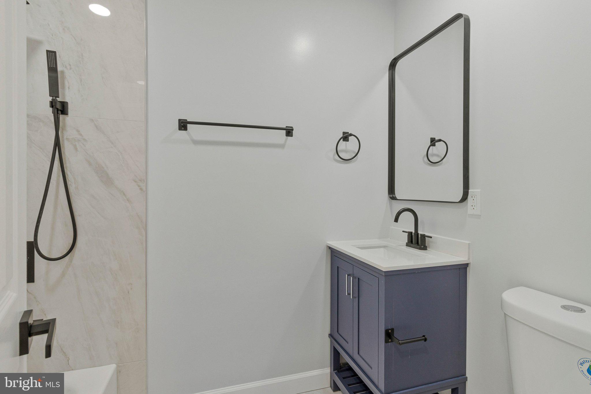 7269 Evanston Road Springfield, VA 22150 - Photo 19 of 41 a bathroom with a sink a light fixture and a shower