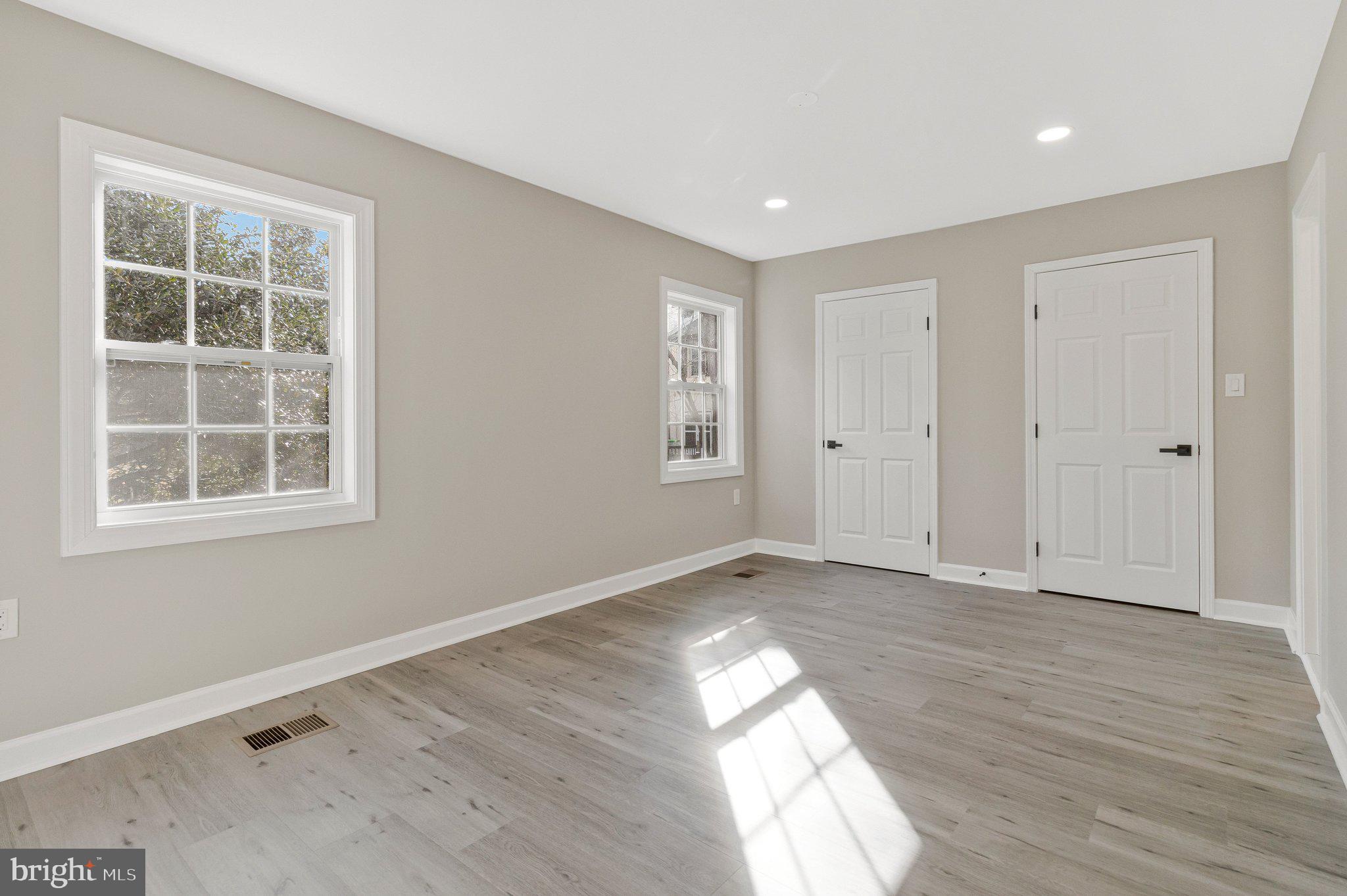 7269 Evanston Road Springfield, VA 22150 - Photo 21 of 41 an empty room with wooden floor and windows