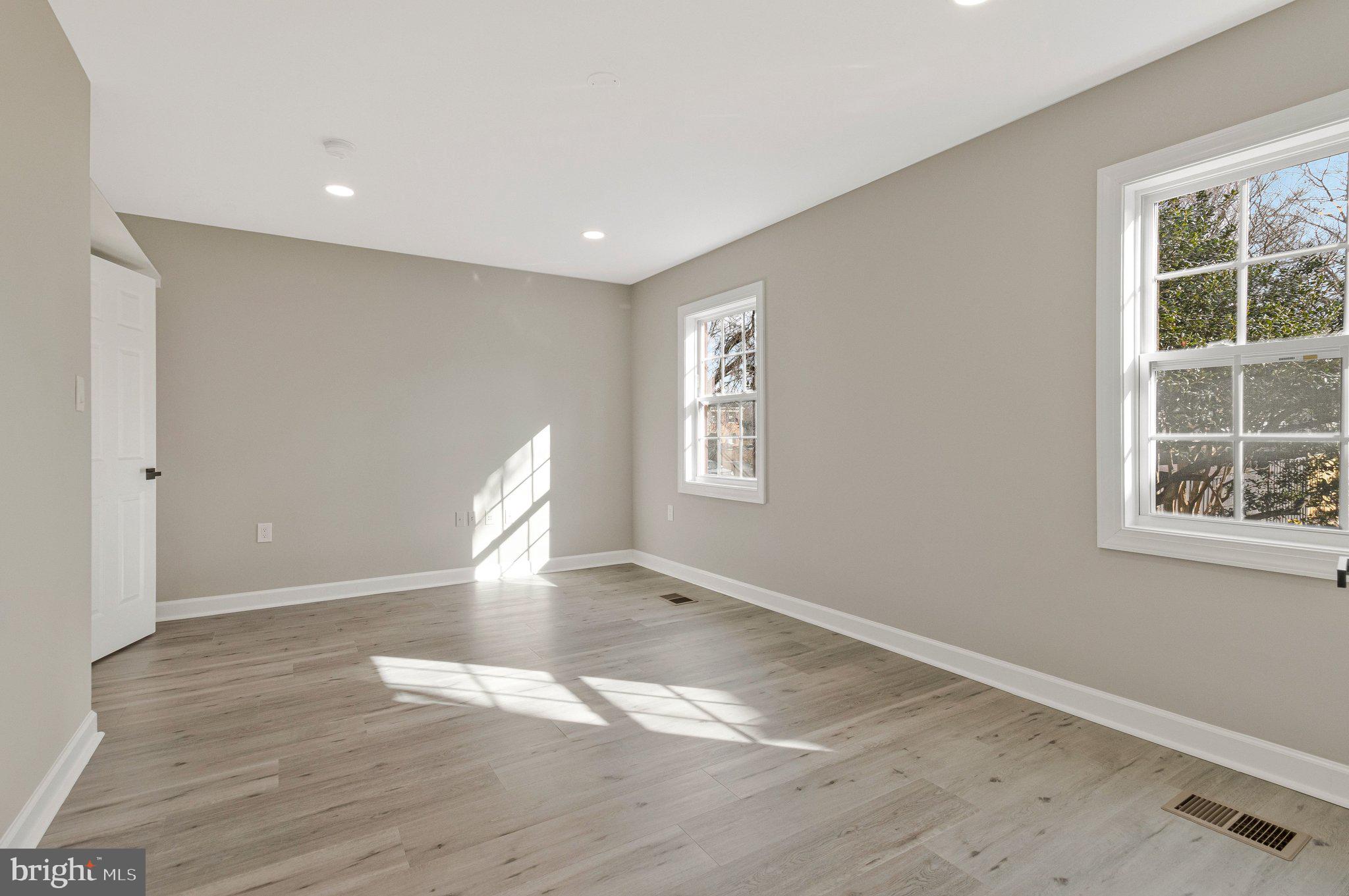 7269 Evanston Road Springfield, VA 22150 - Photo 23 of 41 an empty room with wooden floor and windows