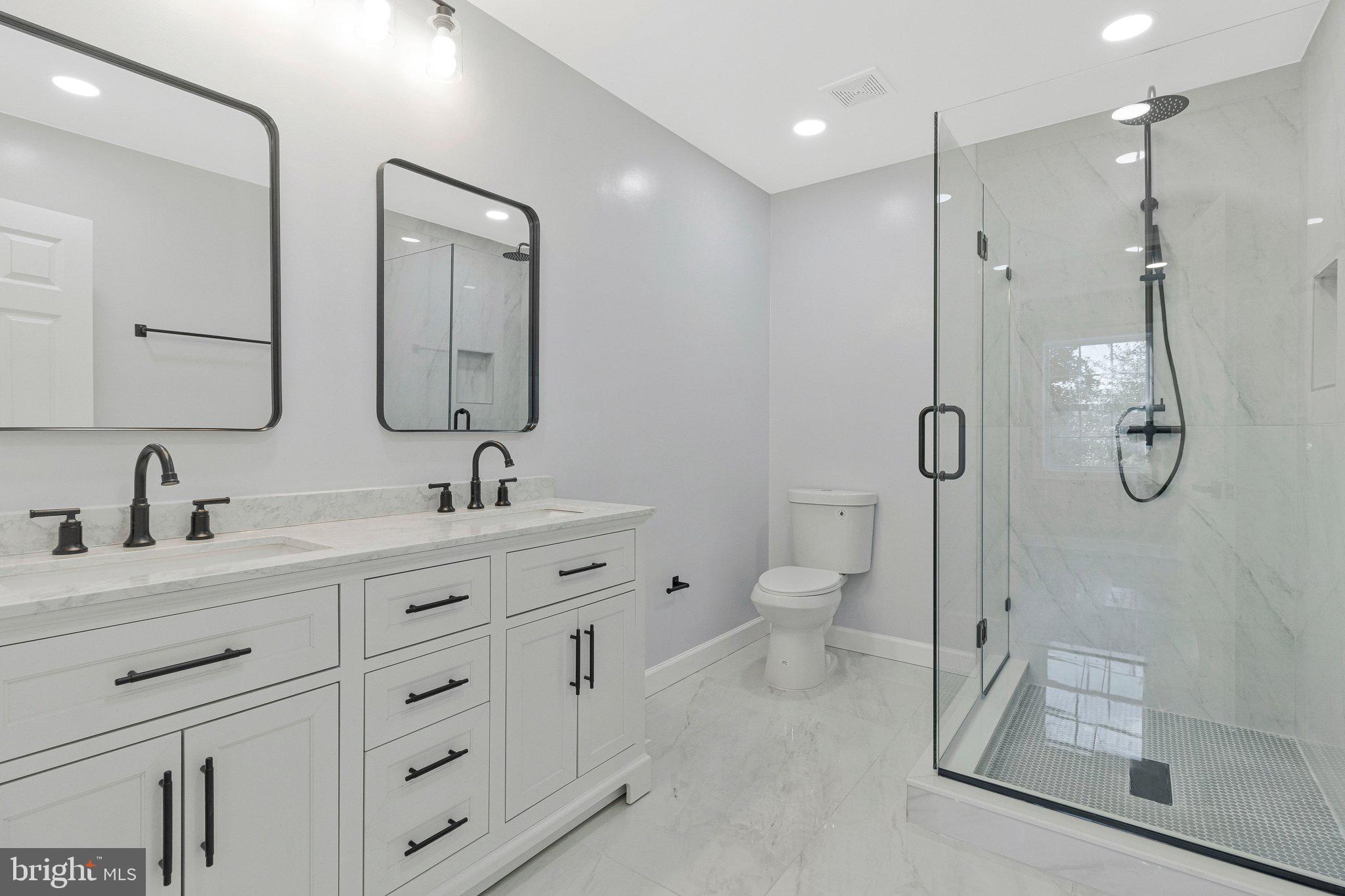 7269 Evanston Road Springfield, VA 22150 - Photo 24 of 41 a bathroom with a double vanity sink mirror and toilet