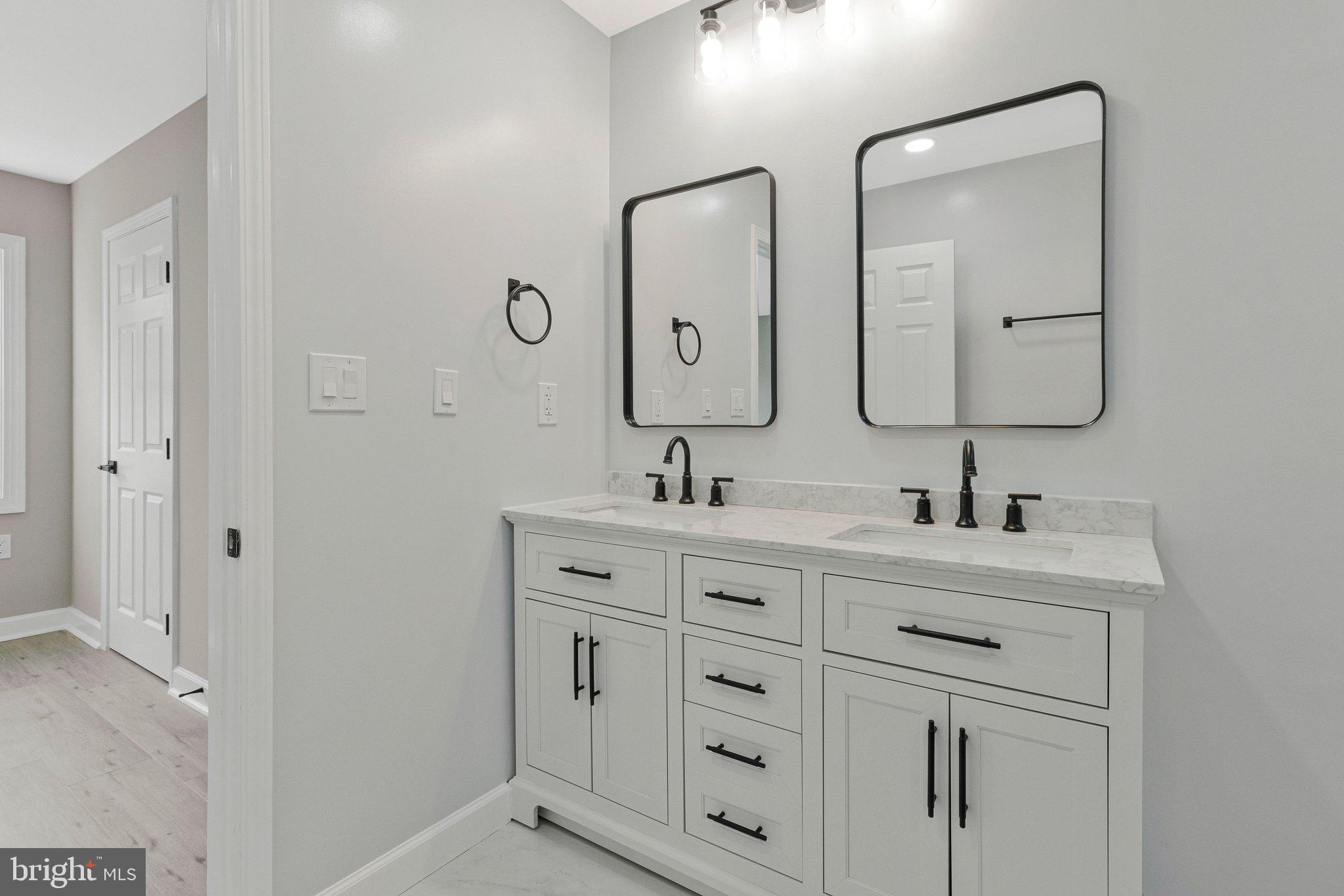 7269 Evanston Road Springfield, VA 22150 - Photo 27 of 41 a bathroom with double vanity sink two mirror and a vanity
