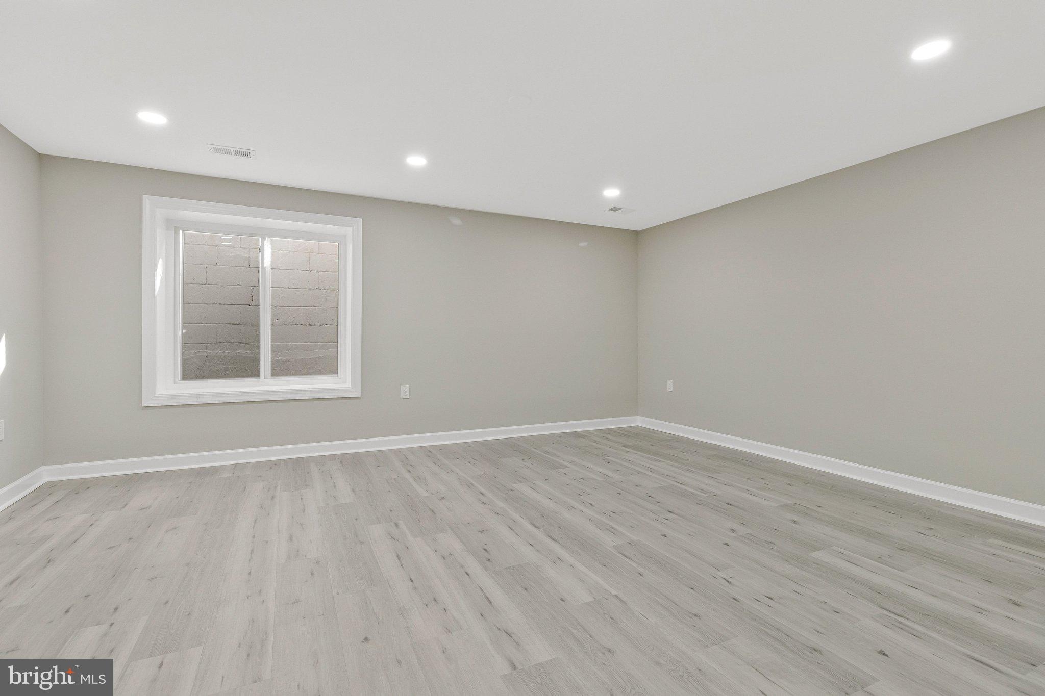 7269 Evanston Road Springfield, VA 22150 - Photo 31 of 41 a view of an empty room with wooden floor and a window