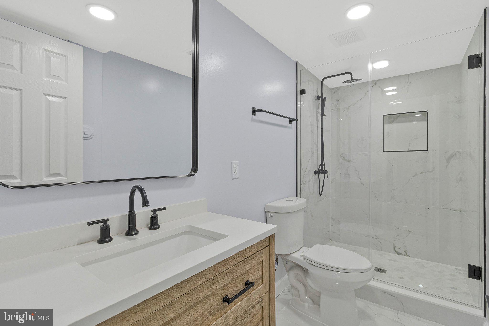 7269 Evanston Road Springfield, VA 22150 - Photo 35 of 41 a bathroom with a sink a toilet and shower