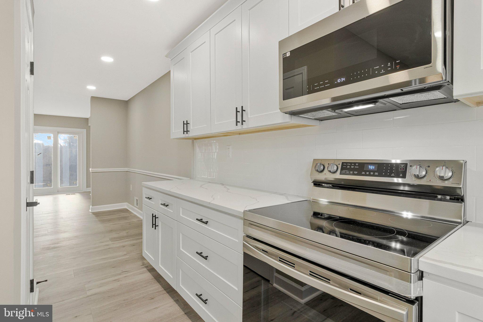 7269 Evanston Road Springfield, VA 22150 - Photo 7 of 41 a kitchen with a stove and a microwave
