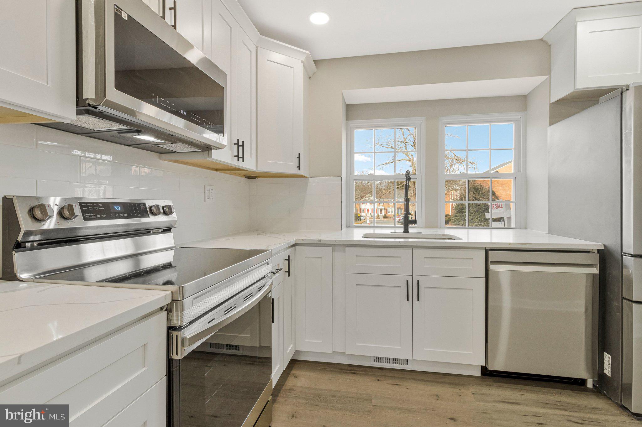7269 Evanston Road Springfield, VA 22150 - Photo 8 of 41 a kitchen with a cabinets and a stove