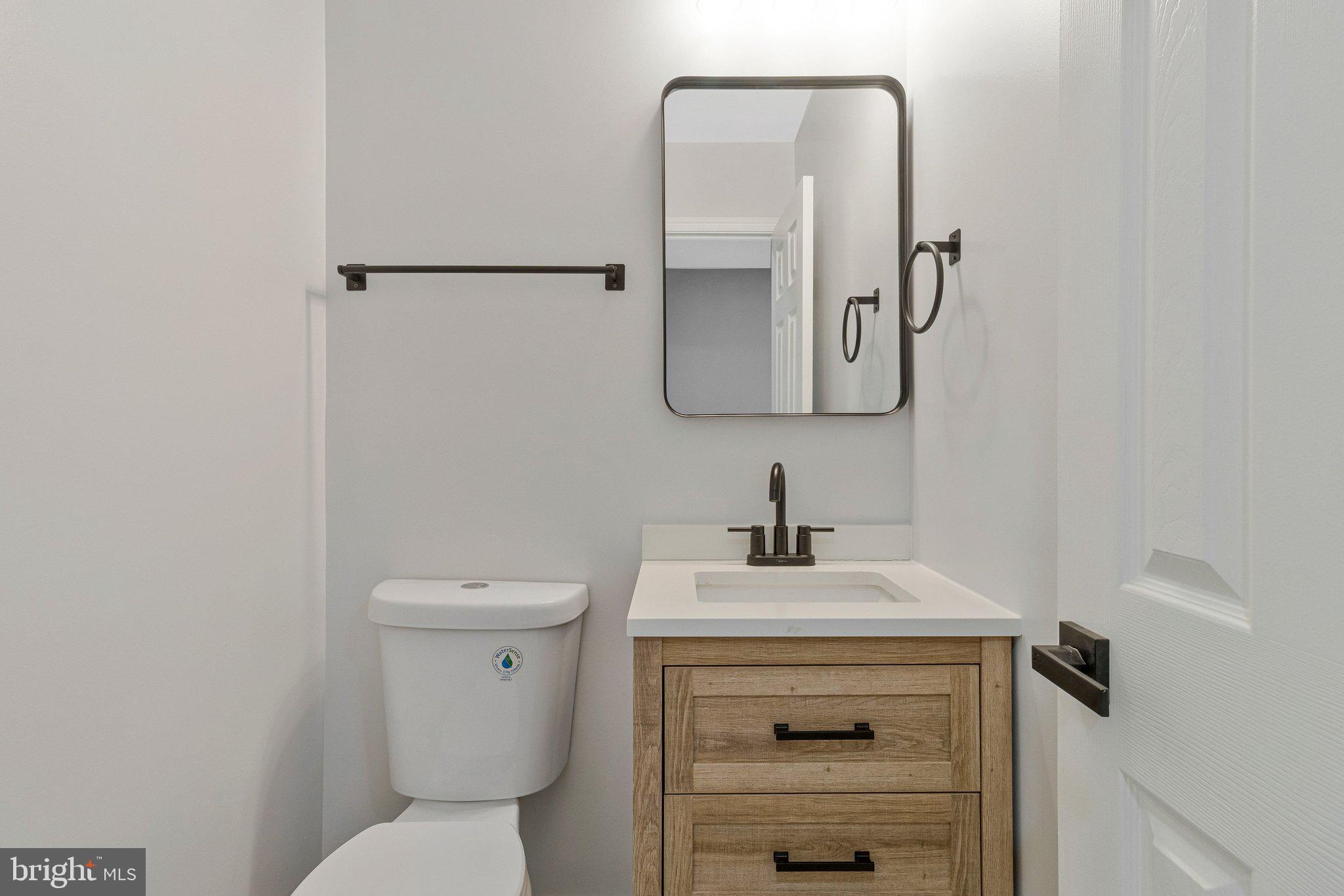 7269 Evanston Road Springfield, VA 22150 - Photo 10 of 41 a bathroom with a toilet sink and mirror