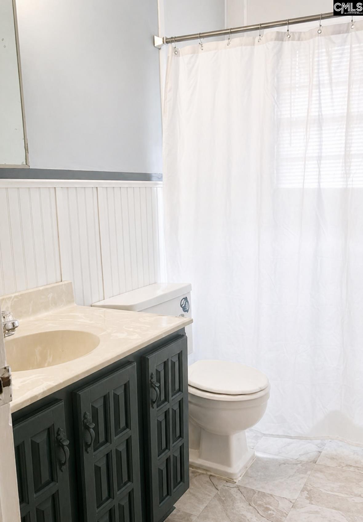 118 State Rd S-38-1224 Cordova, SC 29039 - Photo 10 of 12 a bathroom with a sink a toilet and a shower curtain