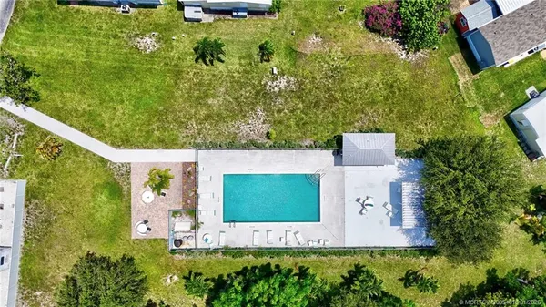 an aerial view of a house with a yard