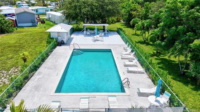 an aerial view of residential houses with outdoor space and street view