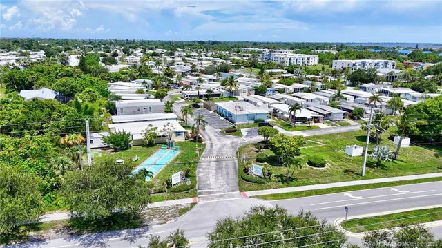 an aerial view of residential houses with outdoor space and street view