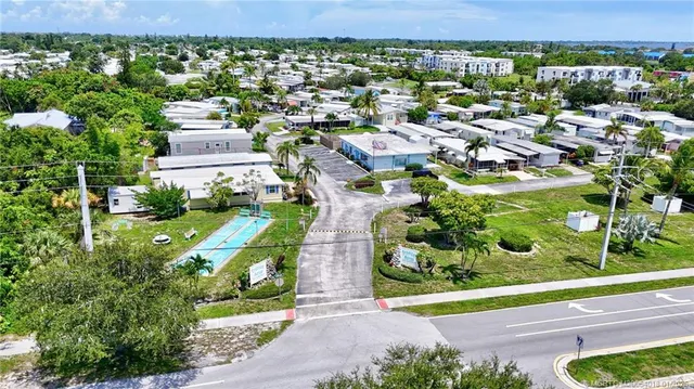 an aerial view of multiple houses with yard