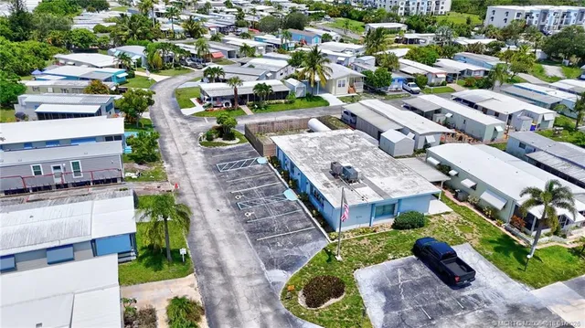 an aerial view of a house with a garden and lake view