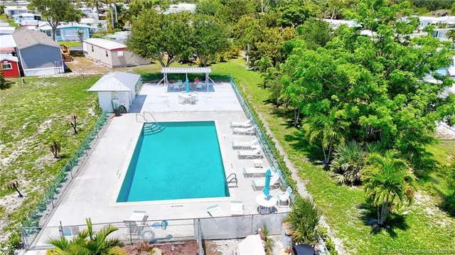 an aerial view of a house with a garden and lake view