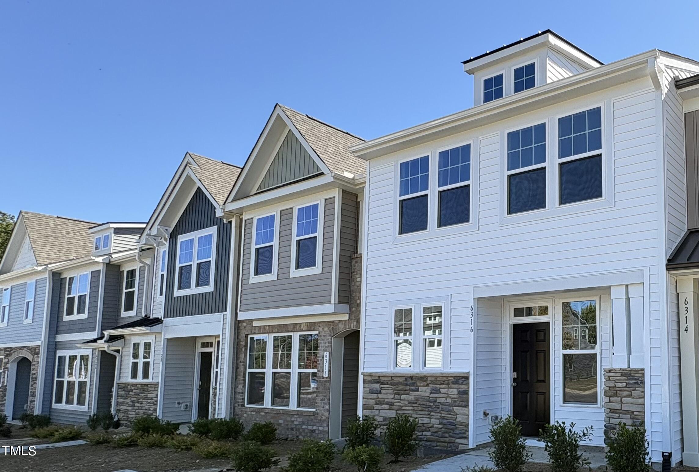 6316 Granite Quarry Drive Raleigh, NC 27610 - Photo 1 of 16 a front view of a house with plants and windows