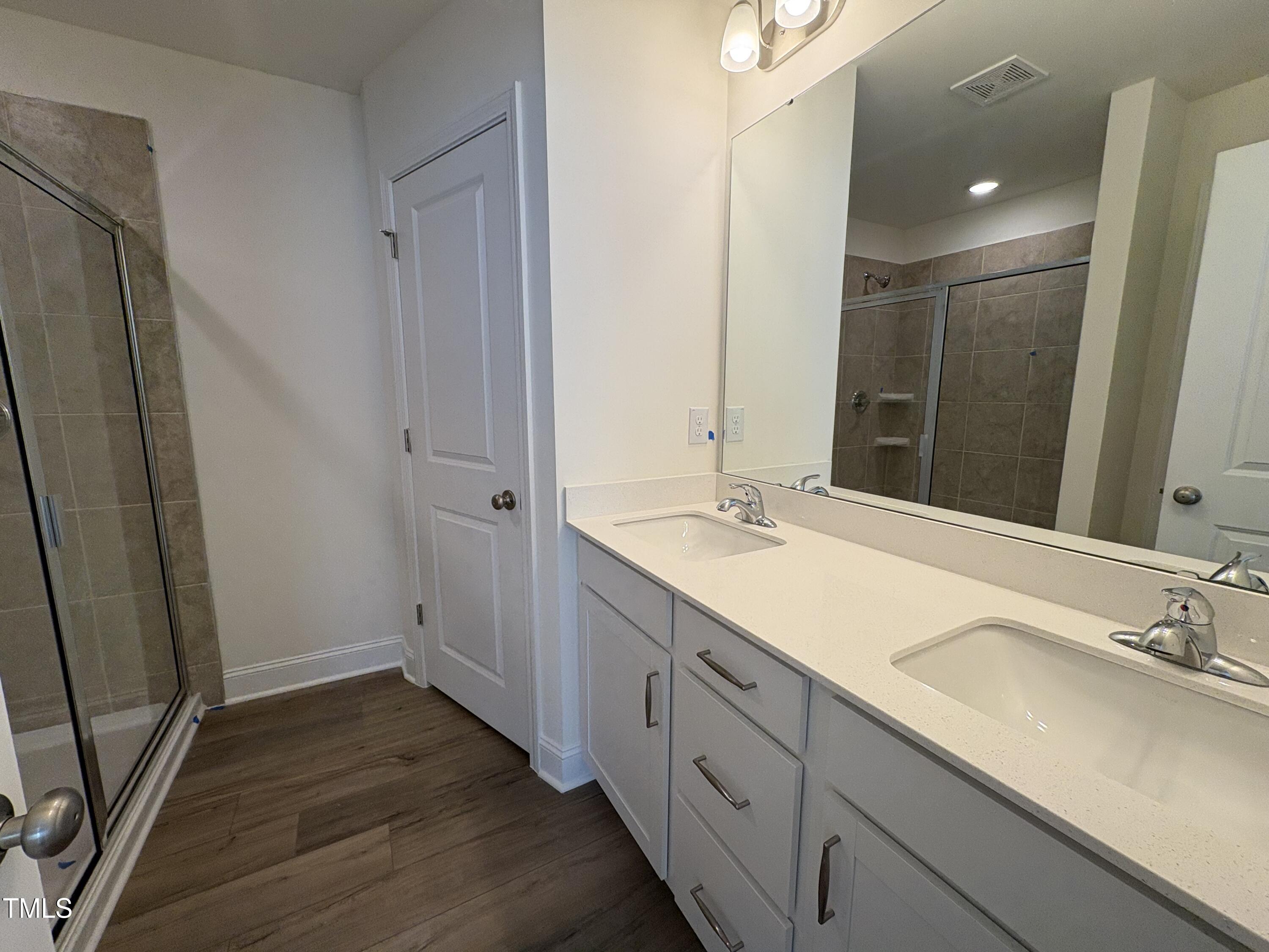 6316 Granite Quarry Drive Raleigh, NC 27610 - Photo 13 of 16 a bathroom with a double vanity sink and mirror