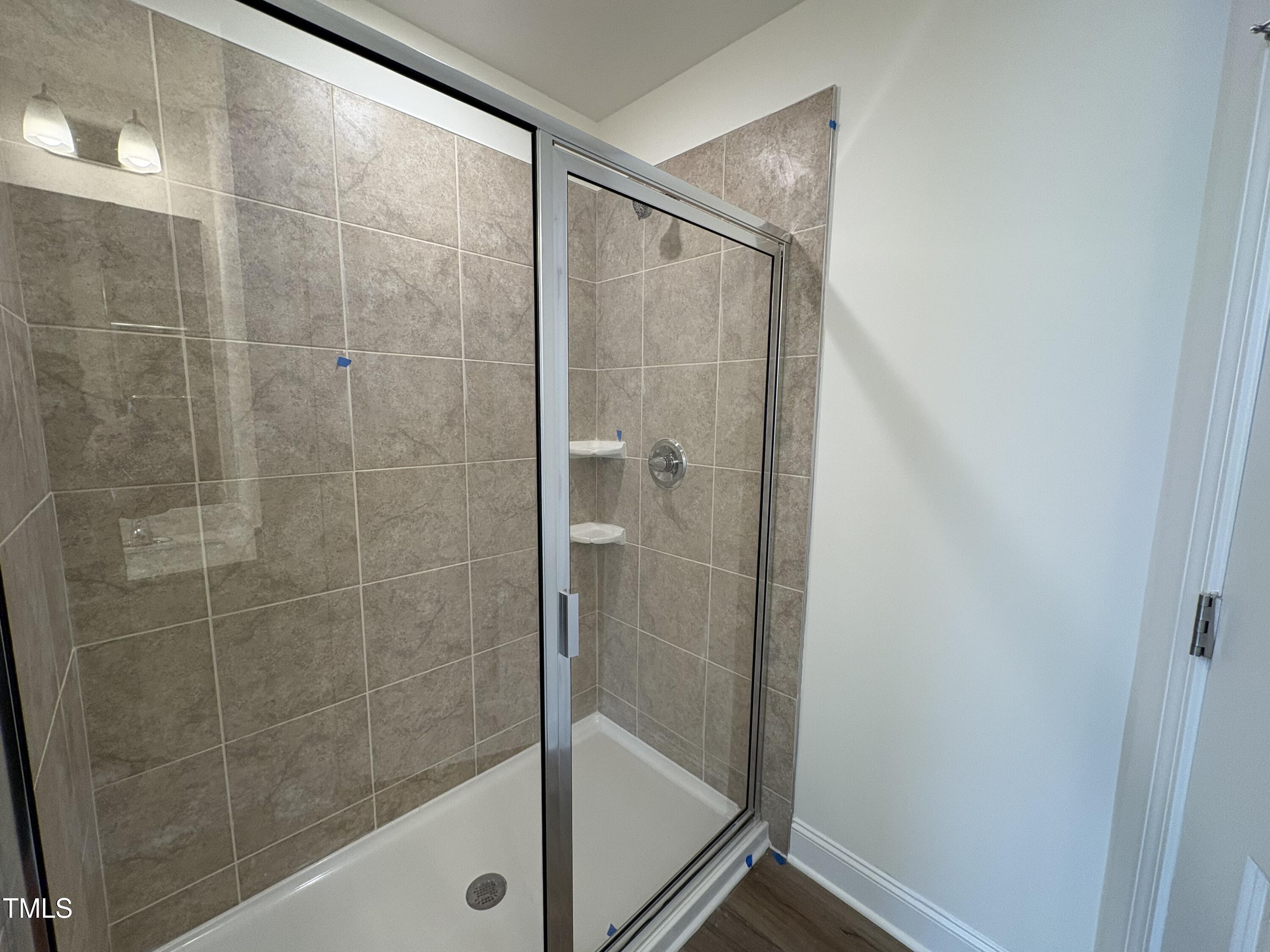 6316 Granite Quarry Drive Raleigh, NC 27610 - Photo 14 of 16 a bathroom with a glass shower door