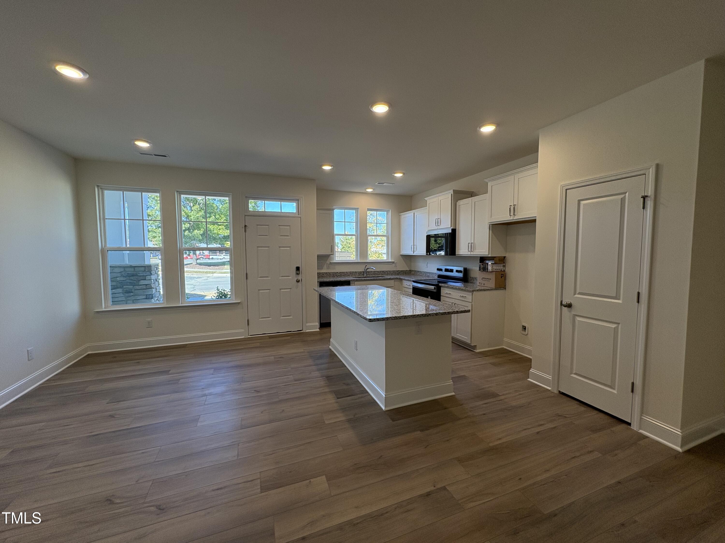 6316 Granite Quarry Drive Raleigh, NC 27610 - Photo 2 of 16 a large kitchen with large window and wooden floor