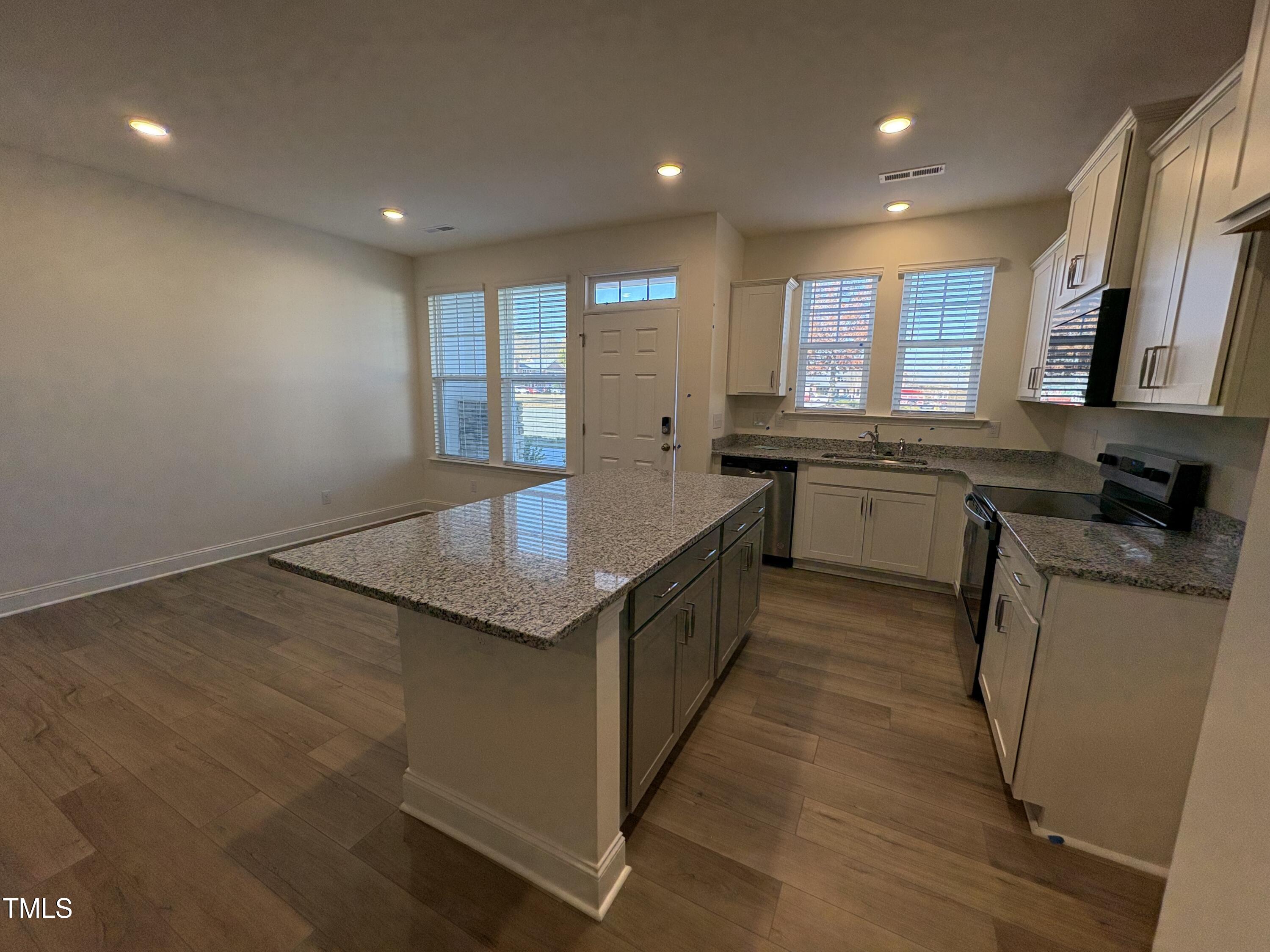6316 Granite Quarry Drive Raleigh, NC 27610 - Photo 5 of 16 a large kitchen with stainless steel appliances granite countertop a lot of counter space and a sink
