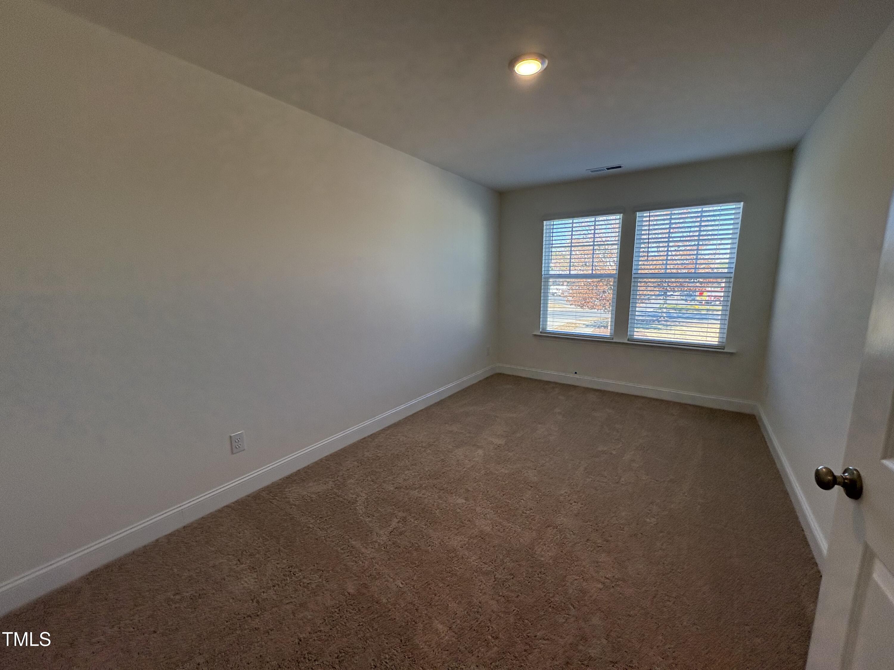 6316 Granite Quarry Drive Raleigh, NC 27610 - Photo 8 of 16 an empty room with a window